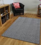 Modern grey rug featuring embossed chevron-inspired design